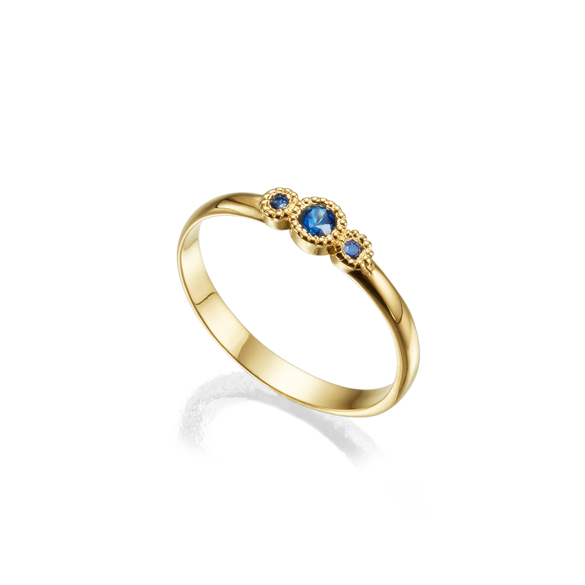 A gold ring set with three sapphires