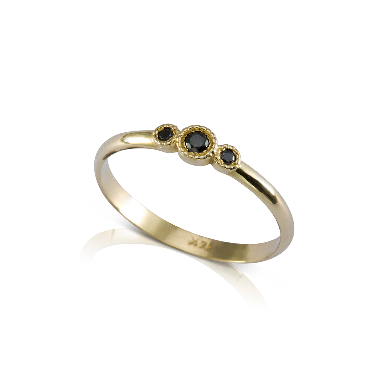 A gold ring set with three black diamonds