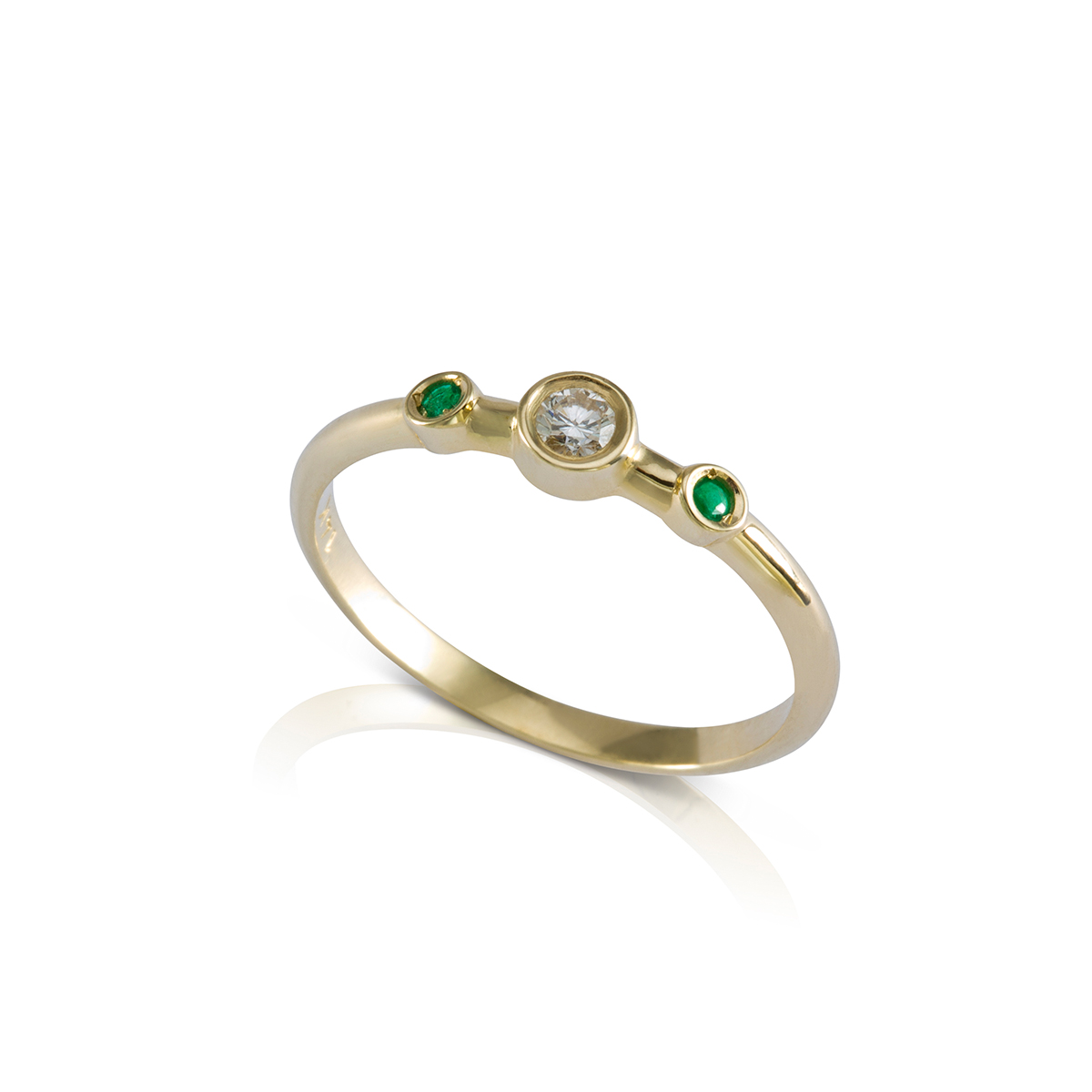 A delicate diamond and emerald ring